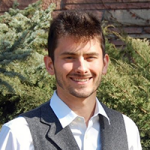 Picture of a smiling man wearing a white shirt and black vest, Jamie Nielson